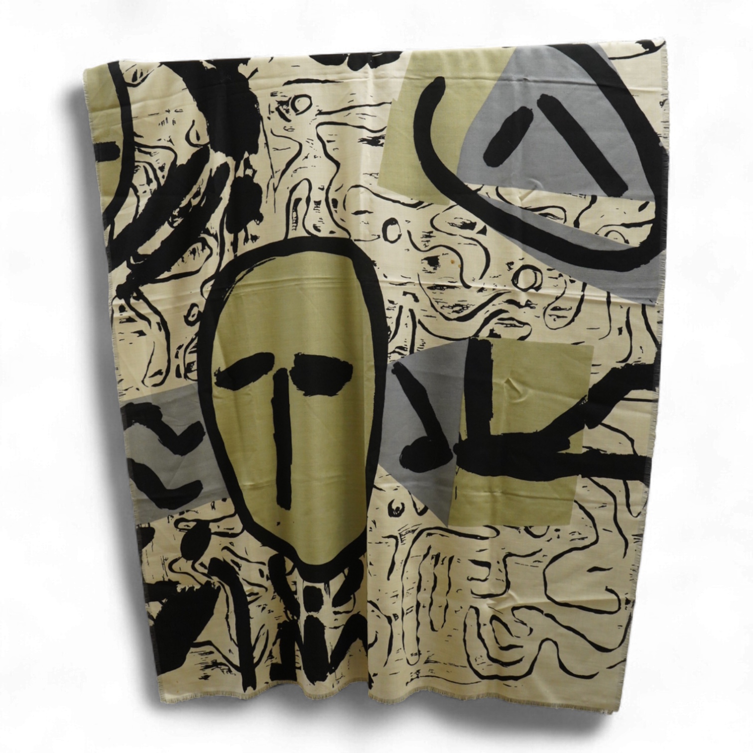 A large wool scarf designed with large faces by Brian Bolger, (RCA 1983) and The Cloth.100cm wide x 140cm. Condition - good
